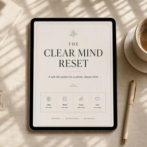 May include: A tablet displaying the text THE CLEAR MIND RESET, A soft-life system for a calmer, clearer mind, with icons for Calm, Reset, Focus, and Live. The screen includes the words MINDFUL, INTENTIONAL, BALANCED at the bottom of the display.