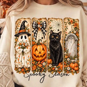 Può includere: Una felpa color crema con una stampa grafica composta da quattro pannelli verticali con illustrazioni a tema autunnale, tra cui un fantasma con cappello da strega, un fiocco a quadri, una zucca, un gatto nero e una lapide con il testo Spooky Season.