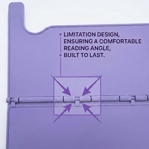 May include: A light purple book stand featuring a hinged design with a central joint mechanism. The surface includes the printed text: LIMITATION DESIGN, ENSURING A COMFORTABLE READING ANGLE, BUILT TO LAST, with arrows pointing to the hinge detail.