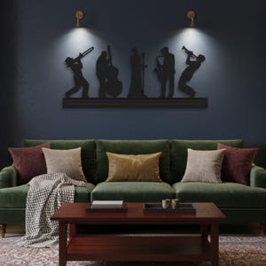 May include: A black metal wall art piece depicting a jazz band silhouette. The artwork features musicians playing various instruments, including a trombone, double bass, saxophone, and trumpet. The art is mounted above a green velvet sofa with decorative pillows and a wooden coffee table.