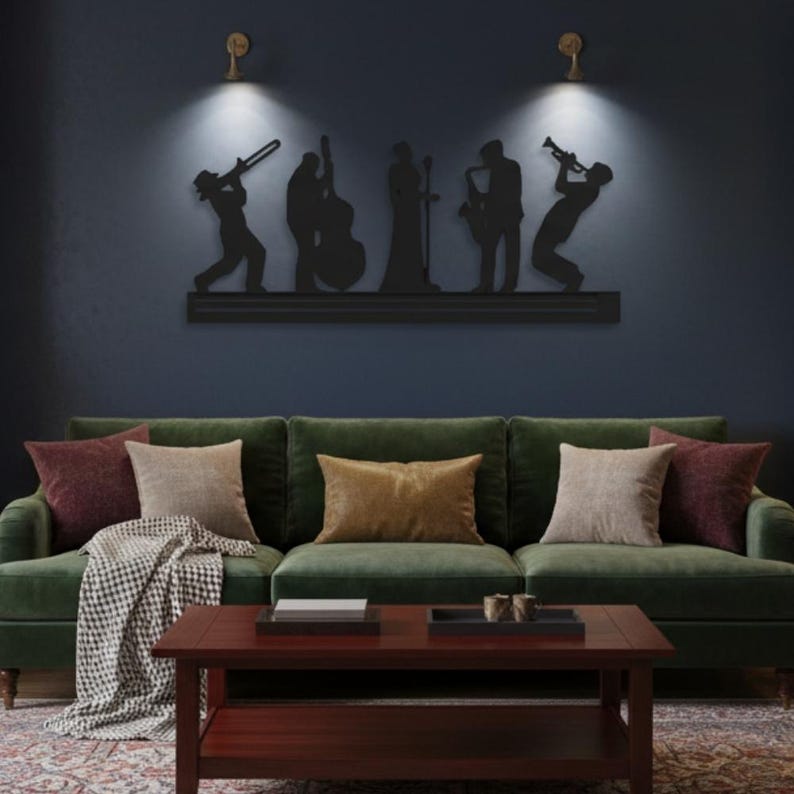 May include: A black metal wall art piece depicting a jazz band silhouette. The artwork features musicians playing various instruments, including a trombone, double bass, saxophone, and trumpet. The art is mounted above a green velvet sofa with decorative pillows and a wooden coffee table.