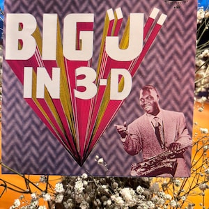 Puede incluir: Una taza de cerámica blanca con asa negra y el texto "But First, Coffee" en estilo manuscrito. La taza está sobre una superficie blanca. Ideal para bebidas calientes.