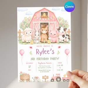 May include: A rectangular birthday party invitation card featuring a watercolor illustration of a pink barn with a sheep, rabbit, horse, pig, and cow. The text reads: You're invited to Rylee's 3rd birthday party, Saturday 17 May, Rylee's Farm.