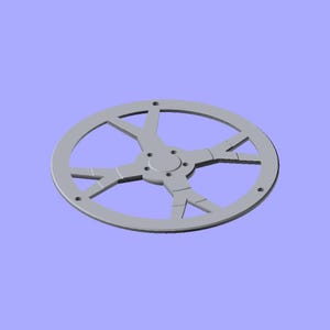 May include: A circular, light grey mechanical component featuring a central hub with four small mounting holes, connected to an outer ring by three Y-shaped spokes. The flat, industrial-style part has a smooth finish and a symmetrical design.