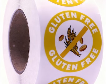 Puede incluir: Un rollo de pegatinas blancas con borde amarillo y las palabras "GLUTEN FREE" en blanco. El centro de la pegatina tiene un símbolo de trigo tachado, que indica un producto sin gluten.