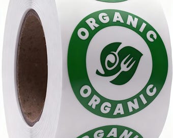 Puede incluir: Un rollo de etiquetas adhesivas blancas con un borde circular verde y la palabra ORGANIC impresa en letras mayúsculas blancas. Dentro del círculo hay un icono gráfico verde que representa una hoja estilizada con una horquilla y una cuchara.