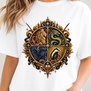 May include: A white t-shirt featuring a circular, ornate gold emblem divided into four quadrants. The design displays a lion, a dragon, a raven, and a badger, surrounded by intricate filigree, stars, wands, and an open book at the bottom.