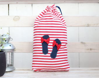 May include: Red and white striped drawstring bag with blue flip-flop appliques. The flip-flops have red bows.
