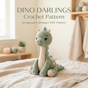 May include: A crocheted dinosaur amigurumi in shades of green, cream, and blue, with the text "DINO DARLINGS Crochet Pattern" above. The dinosaur has a long neck, small horns, and blue spots. It is sitting on a beige surface.