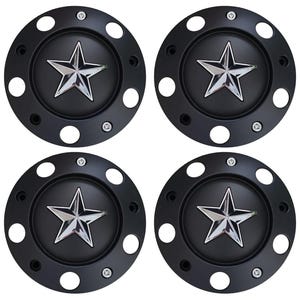 May include: Four black wheel center caps with a chrome star emblem in the center. Each cap has a series of small white circular holes around the edge and is secured with small screws.
