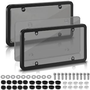 May include: Three black license plate frames with clear, tinted covers. The frames have rounded corners and include mounting hardware such as screws, washers, and bolt caps. The covers are transparent, allowing visibility of the license plate.