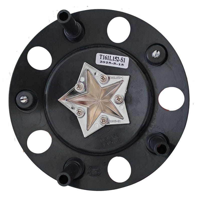 May include: A black plastic hubcap with a silver and gold star emblem in the center. The hubcap has several holes and protruding tubes. The text "T161L152-S1" and "2025-5-15" is printed on a white sticker.