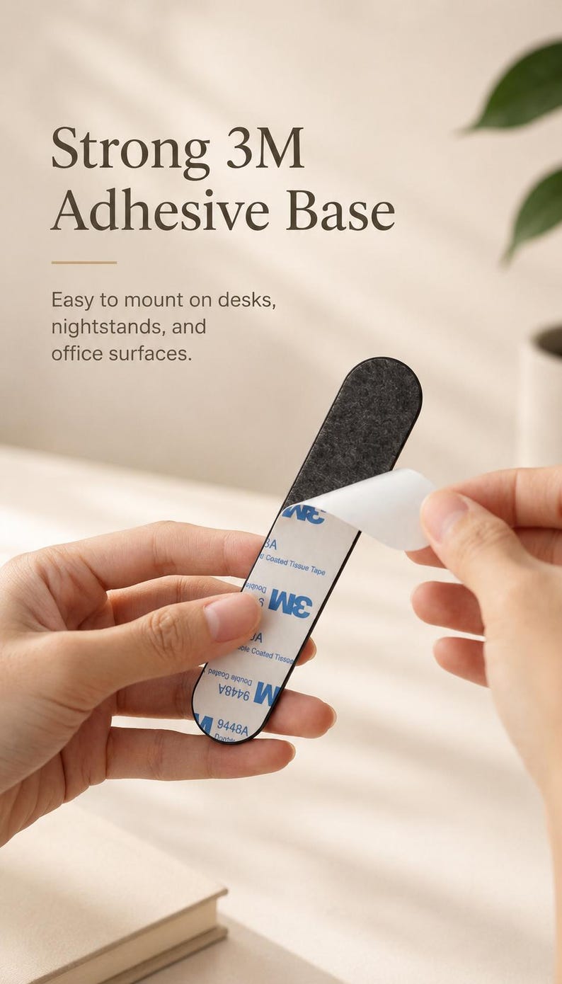 May include: A narrow, elongated strip with a dark gray felt-like top surface and a white adhesive backing labeled with 3M 9448A Double Coated Tissue Tape branding. The white protective film is partially peeled back to reveal the sticky adhesive layer.