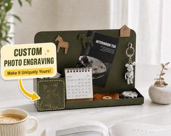May include: A dark green metal desk organizer featuring a custom cat photo engraving on the front panel. The organizer holds a small 2024 calendar, a black card with the text AFTERNOON TEA, two horse-shaped magnets, and a silver bear keychain.