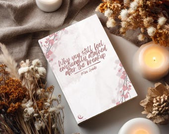 Pode incluir: Um livro retangular com capa branca apresentando ramos de flores de cerejeira cor-de-rosa e o texto Why you still feel emotionally attached after the breakup Mini Guide. O livro inclui um pequeno logótipo na parte inferior com uma lua crescente e uma estrela.