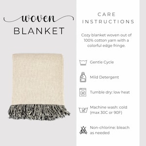May include: A woven blanket with a cream-colored body and a black and white fringe. The text "woven BLANKET" is at the top left. Care instructions include gentle cycle, mild detergent, tumble dry low heat, and machine wash cold.