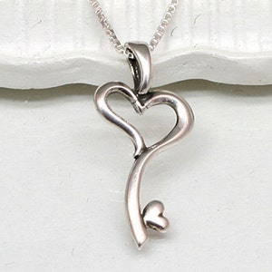 May include: A silver key pendant necklace with a heart-shaped keyhole and a small heart at the bottom of the key.