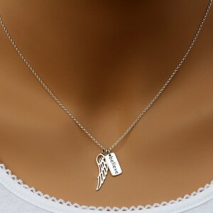 May include: A silver chain necklace with a small silver charm that says "believe" and a silver angel wing pendant.