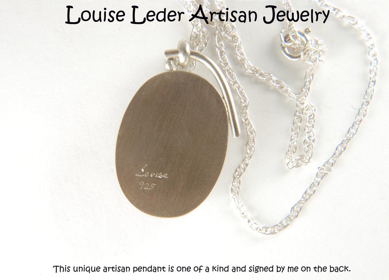 May include: A silver oval pendant necklace with a sterling silver chain. The pendant is signed "Louise 925" on the back. This unique artisan pendant is one of a kind and signed by me on the back.