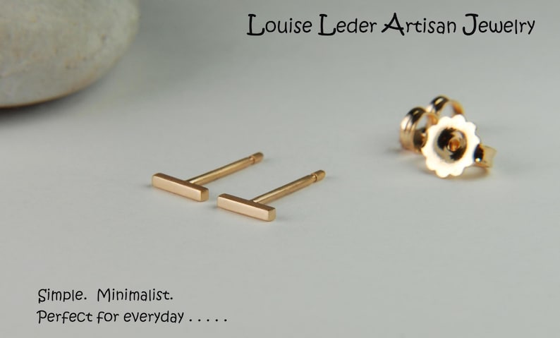 May include: A pair of gold bar stud earrings. The earrings are simple and minimalist.  "Simple. Minimalist. Perfect for everyday..."