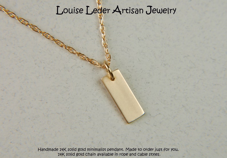 May include: A minimalist gold pendant necklace. The rectangular pendant hangs from a delicate gold chain. The jewelry is displayed on a light-colored surface. The text "Louise Leder Artisan Jewelry" is visible.
