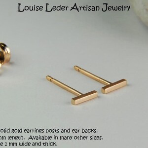 May include: A pair of 14K gold bar earrings with posts and ear backs. The earrings are shown in the 5 mm length. Handmade solid gold earrings. The bars measure 1 mm wide and thick.