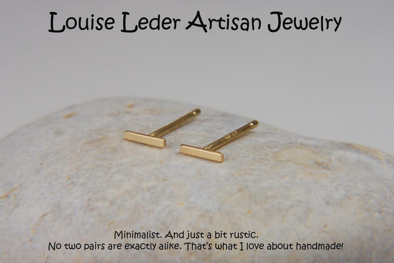 May include: A pair of gold-colored bar stud earrings. The earrings are displayed on a light-colored, textured surface. The text "Louise Leder Artisan Jewelry" is at the top. The text "Minimalist. And just a bit rustic. No two pairs are exactly alike. That's what I love about handmade!" is at the bottom.