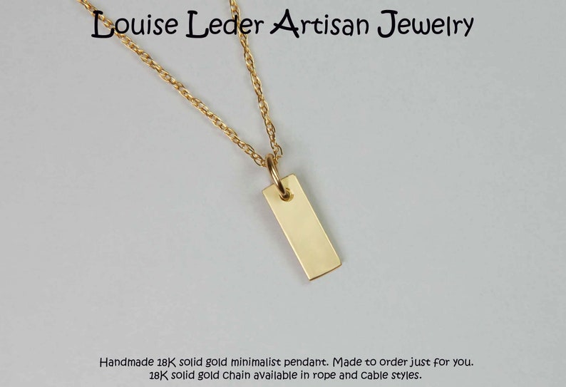 May include: A minimalist gold pendant necklace. The rectangular pendant hangs from a delicate gold chain. The text "Louise Leder Artisan Jewelry" is at the top. The necklace is handmade.