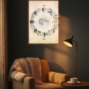 Puede incluir: Una l&aacute;mina de arte mural enmarcada que muestra un diagrama circular de las fases lunares, incluyendo luna nueva, creciente, cuarto, gibosa y llena. La ilustraci&oacute;n est&aacute; rodeada de elementos bot&aacute;nicos sobre un fondo de color crema.