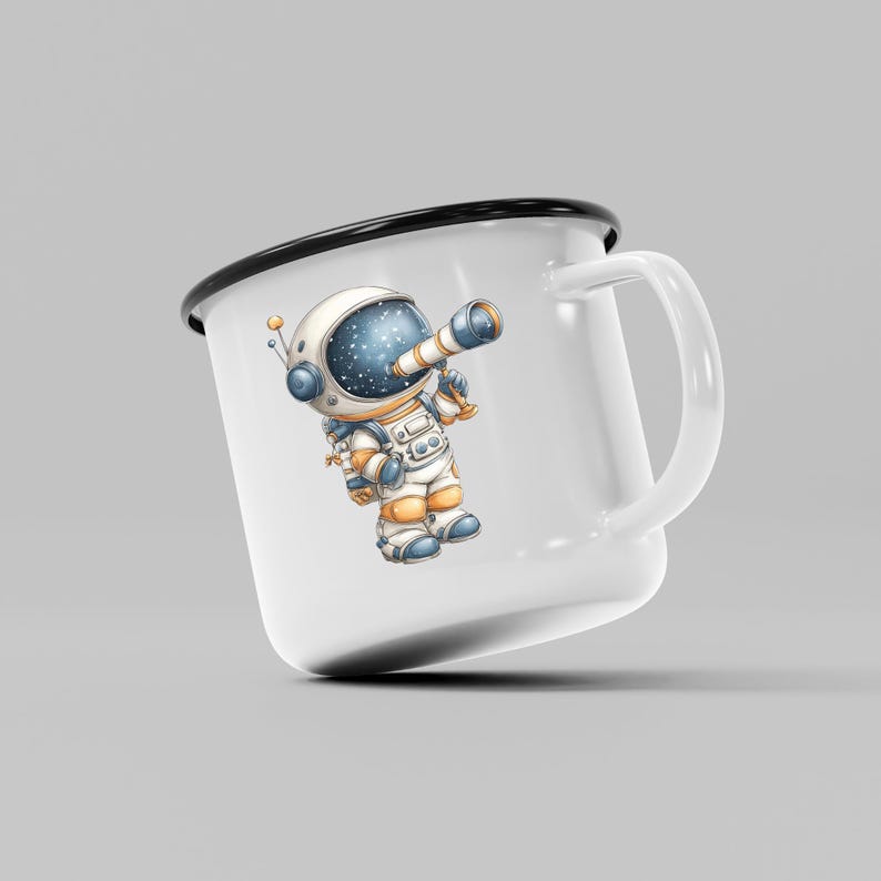 May include: White enamel mug with a black rim and handle. The mug features a cartoon astronaut with a telescope, dressed in a white and orange spacesuit. The astronaut's helmet shows a starry night sky.