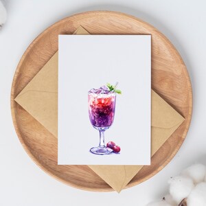 May include: A watercolor greeting card featuring a vibrant cocktail with purple and red hues, ice, and a mint garnish. The card is on a wooden tray with a brown envelope, suggesting a theme of beverages or celebrations.