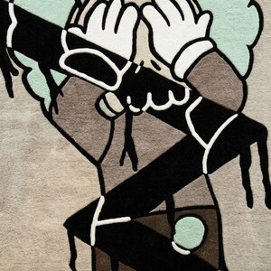 Detailed view of artistic character rug highlighting clean tufting lines, textured wool fibers, and modern street art inspired design