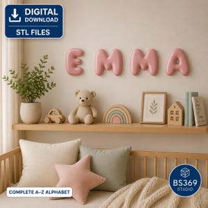 May include: A digital download of STL files for 3D printable letters spelling EMMA in a rounded, bubble-style font. The letters are pink and mounted on a wall above a wooden shelf containing a potted plant, teddy bear, and decor items.