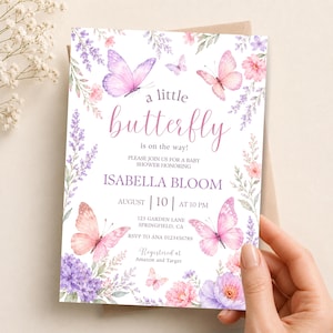 May include: A rectangular baby shower invitation card featuring watercolor illustrations of pink and purple butterflies and floral arrangements. The text reads: a little butterfly is on the way! PLEASE JOIN US FOR A BABY SHOWER HONORING ISABELLA BLOOM.
