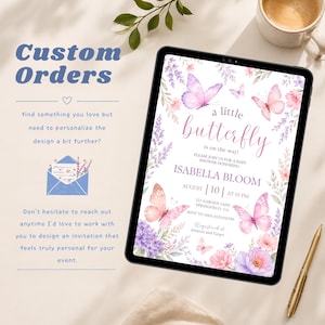 May include: A digital tablet displaying a baby shower invitation with watercolor butterflies and floral accents. The text reads: a little butterfly is on the way! Please join us for a baby shower honoring Isabella Bloom, August 10 at 10 PM.