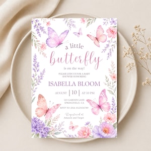 May include: A rectangular baby shower invitation card featuring watercolor illustrations of pink and purple butterflies, lavender sprigs, and floral clusters. The text reads: a little butterfly is on the way! Please join us for a baby shower honoring Isabella Bloom, August 10 at 10 PM, 123 Garden Lane, Springfield, CA, RSVP to Ana 0123456789, Registered at Amazon and Target.