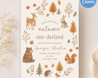 Può includere: Un biglietto d'invito con illustrazioni ad acquerello di un cervo, un coniglio, un orso, uno scoiattolo e un riccio circondati da foglie e alberi autunnali. Il testo recita: Please join us for a autumn one-derland, first birthday in honor of Juniper Harlow, Saturday, December 14th at 2 P.M., Jen's Sweet Shop.