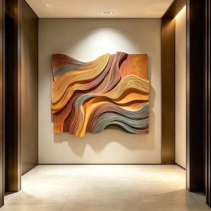 May include: A large, abstract wall art piece with a layered, wave-like design. The artwork features warm tones of orange, yellow, and brown, with accents of green and red. The piece is mounted on a neutral wall in a well-lit hallway.