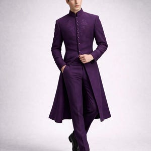 May include: A formal purple suit with a long coat. The coat features a mandarin collar and decorative embroidery on the chest and sleeves. The suit includes matching trousers and black dress shoes.