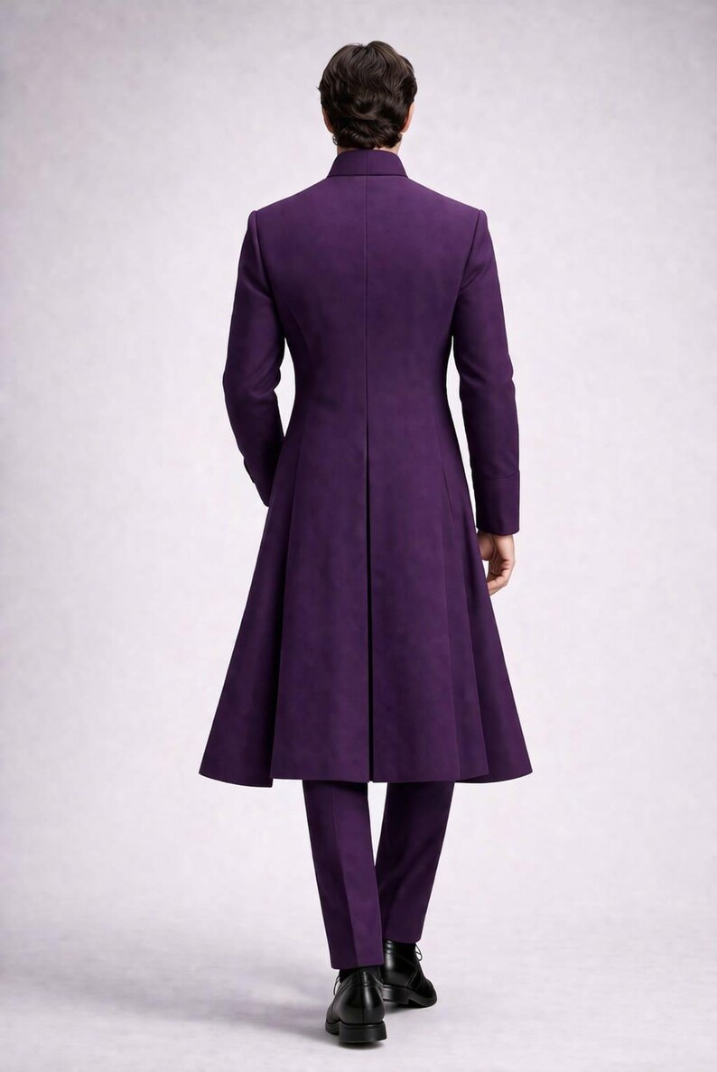 May include: A full-length, purple suit with a long coat and matching trousers. The coat has a high collar and a flared skirt. The trousers are straight-legged. The suit is made of a smooth fabric and is worn with black shoes.