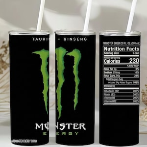 May include: Three black Monster Energy drink tumblers with white straws. Each tumbler has a green Monster logo. One tumbler displays the nutrition facts, including 230 calories. The text "TAURINE + GINSENG" is printed on one tumbler.