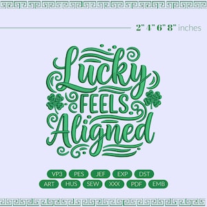 May include: Green embroidered design with the words "Lucky Feels Aligned" and shamrock accents. The design is displayed on a light purple background. The image also includes the measurements 2" 4" 6" 8" inches.