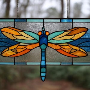 May include: A rectangular stained glass panel featuring a central dragonfly with vibrant orange and teal wings. The dragonfly body is composed of various shades of blue glass. The background consists of clear textured glass and blue borders.