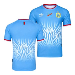 May include: A light blue short-sleeve soccer jersey featuring a white zebra-like pattern on the lower half, a red collar and sleeve trim, the Umbro logo, the Democratic Republic of the Congo flag, and the FECOFA crest with two yellow stars.