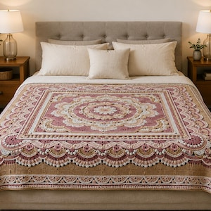 Puede incluir: Una manta de ganchillo rectangular con un patrón de mandala central en tonos rosa empolvado, crema y beige. El diseño incluye motivos circulares intrincados, bordes festoneados y un borde texturizado, extendida sobre una cama con almohadas.