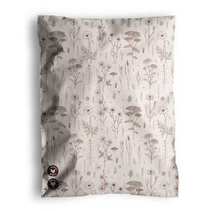 May include: A beige package with a repeating pattern of brown botanical illustrations, including flowers and foliage. The package has three circular stickers on the bottom left corner. The design gives a natural, earthy feel.