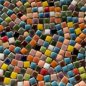 May include: A mosaic tile design featuring a vibrant array of small, square tiles. The tiles are in various colors, including blue, green, yellow, orange, and brown. The arrangement creates a visually appealing, textured surface.