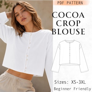 May include: A white long-sleeve crop blouse with a round neckline and a front button closure. The image includes a technical line drawing of the garment, the text "COCOA CROP BLOUSE," "PDF PATTERN," "Sizes: XS-3XL," and "Beginner Friendly."