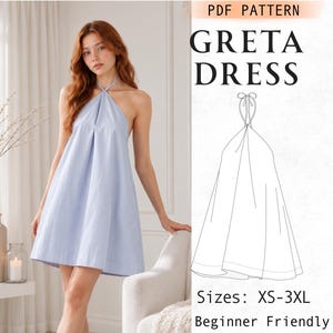May include: A light blue halter-neck dress with a flared silhouette and thin neck ties. The image includes a technical line drawing labeled PDF PATTERN GRETA DRESS with sizes XS-3XL and the text Beginner Friendly printed on the right side.