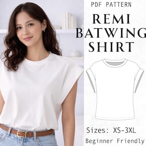 May include: A white batwing shirt with a crew neckline and short sleeves. The image includes text reading PDF PATTERN REMI BATWING SHIRT, Sizes: XS-3XL, and Beginner Friendly, alongside a black and white line drawing of the shirt design.
